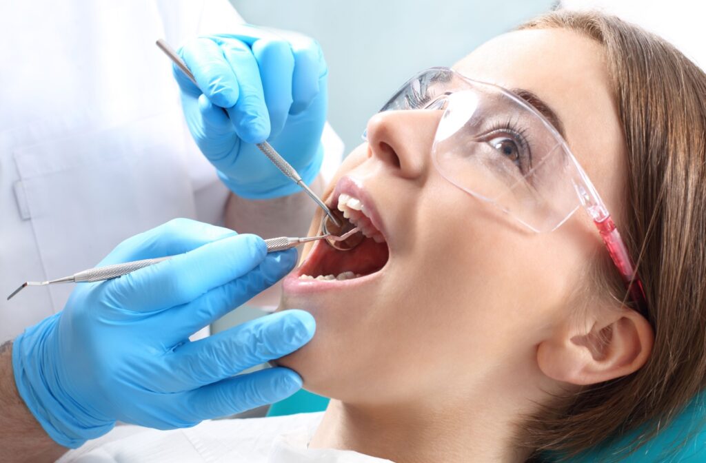 A young woman undergoing dental cleaning.