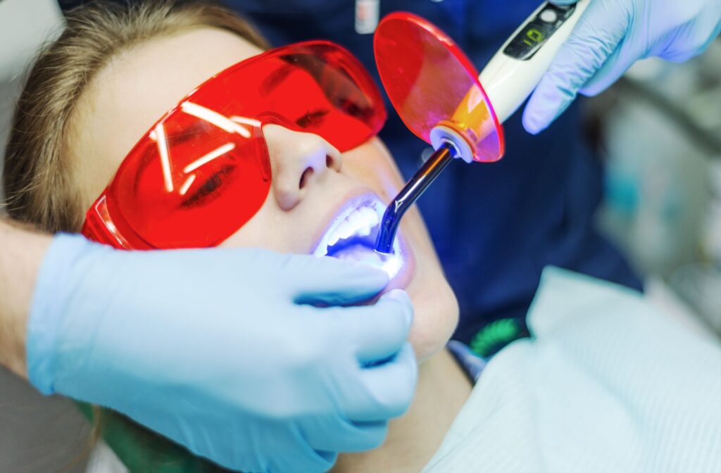 A woman undergoing a laser teeth whitening procedure.